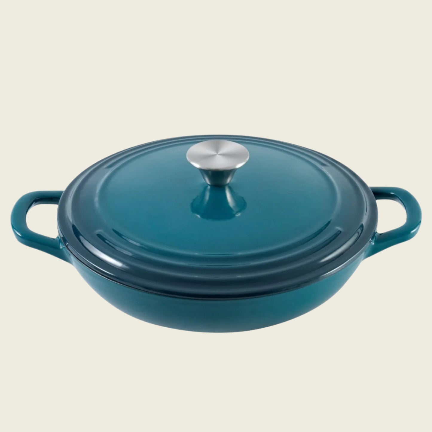 A dark cyan enameled cast iron braiser with a lid, featuring a round shape and two handles.