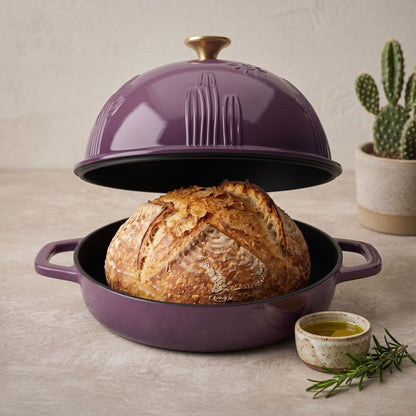 Plum purple cast iron bread oven with domed lid, open base holding rustic loaf