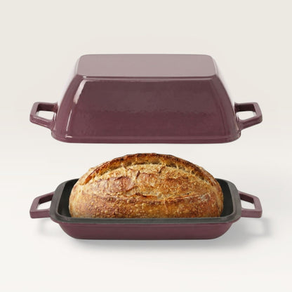 Plum purple oval bread oven with lid, holding a loaf in a black base tray