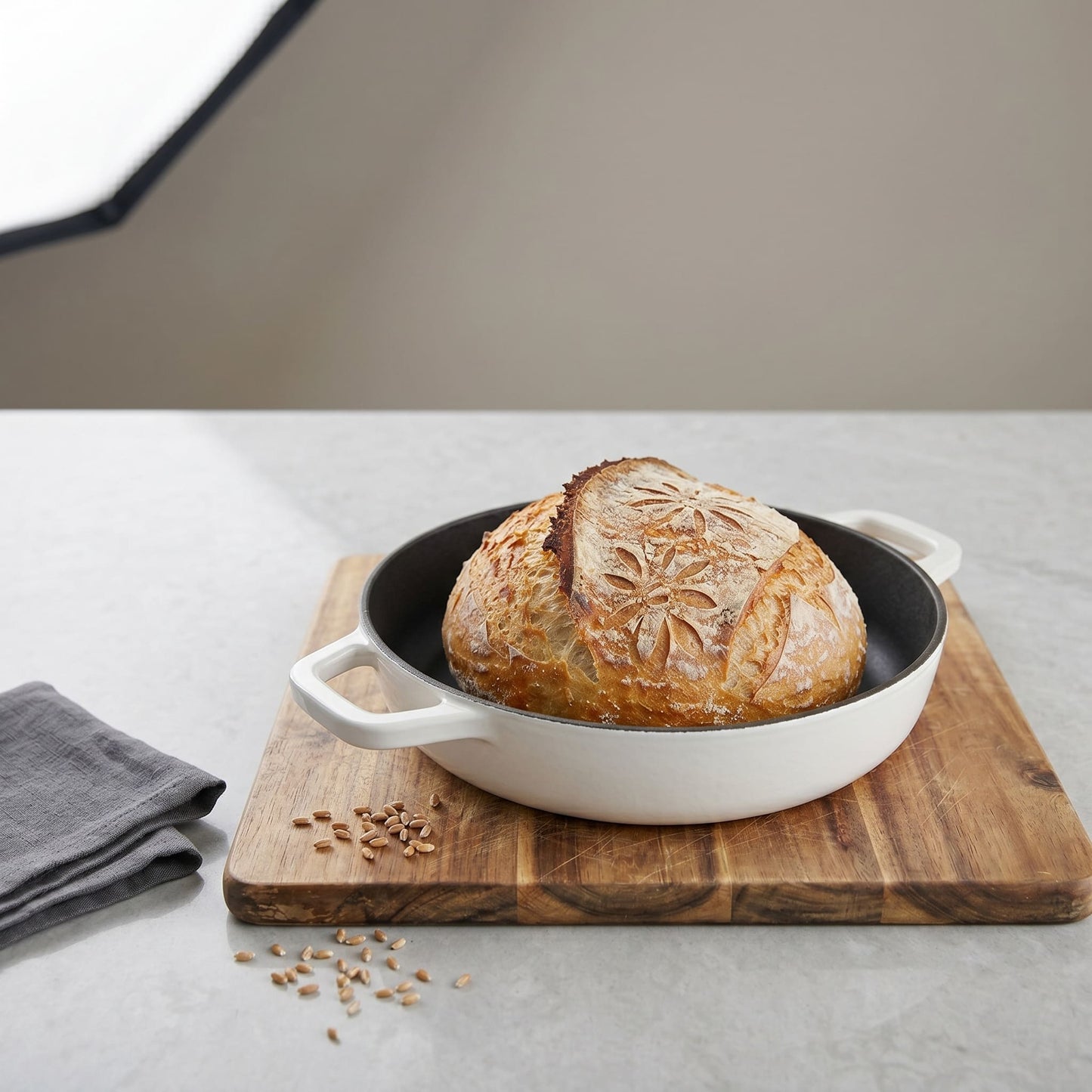 Cactus Bread Oven in Pearl White holding a baked round loaf