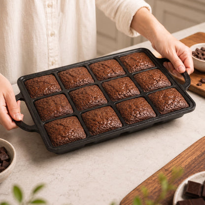 Rectangular brownie pan with 12 cavities holding baked brownies, ready to serve