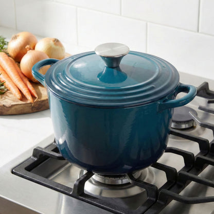 Dark cyan Dutch oven with lid on a gas stove, side handles visible