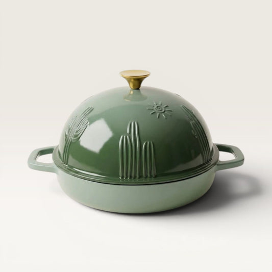 Sage green enamel bread oven lid with gold knob and side handles, front view.