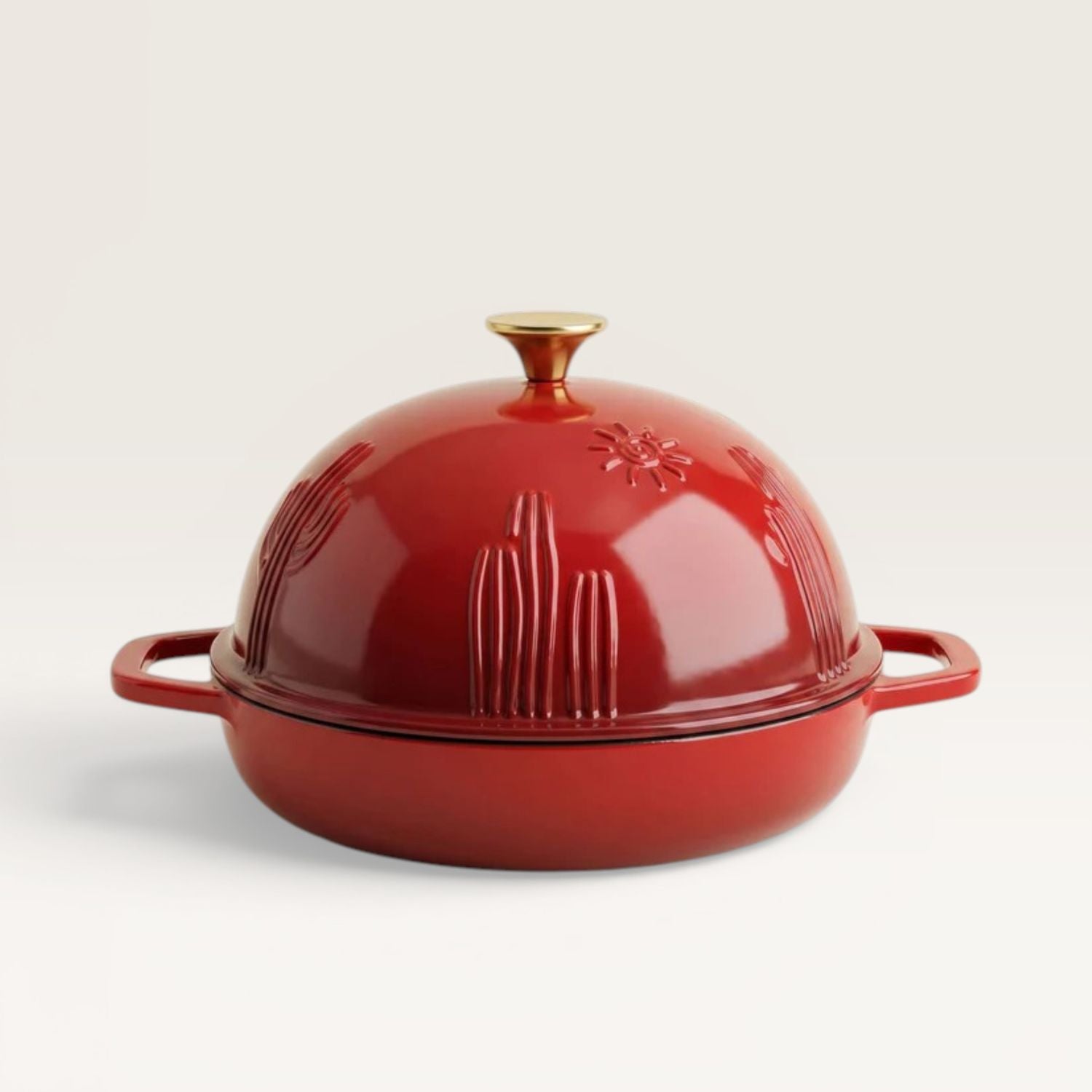 Red enamel bread oven with gold knob and matching side handles.
