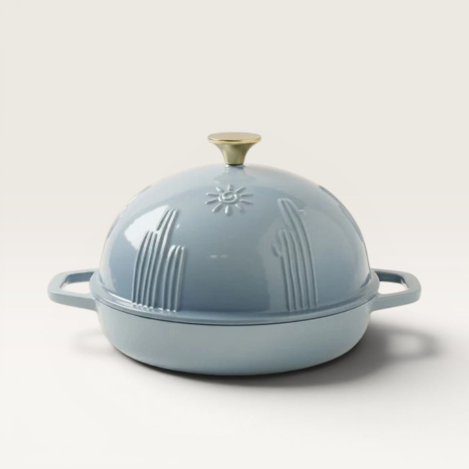 Bread oven lid with handle knob, slate-blue exterior with embossed cactus design.