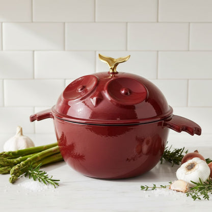 Red owl-shaped cocotte with side handles and gold finial on top lid