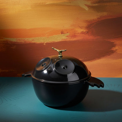 black owl-shaped dutch oven with gold knob, owl-face lid, and side handles