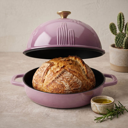 rose pink bread oven with domed lid and sliced loaf on black base