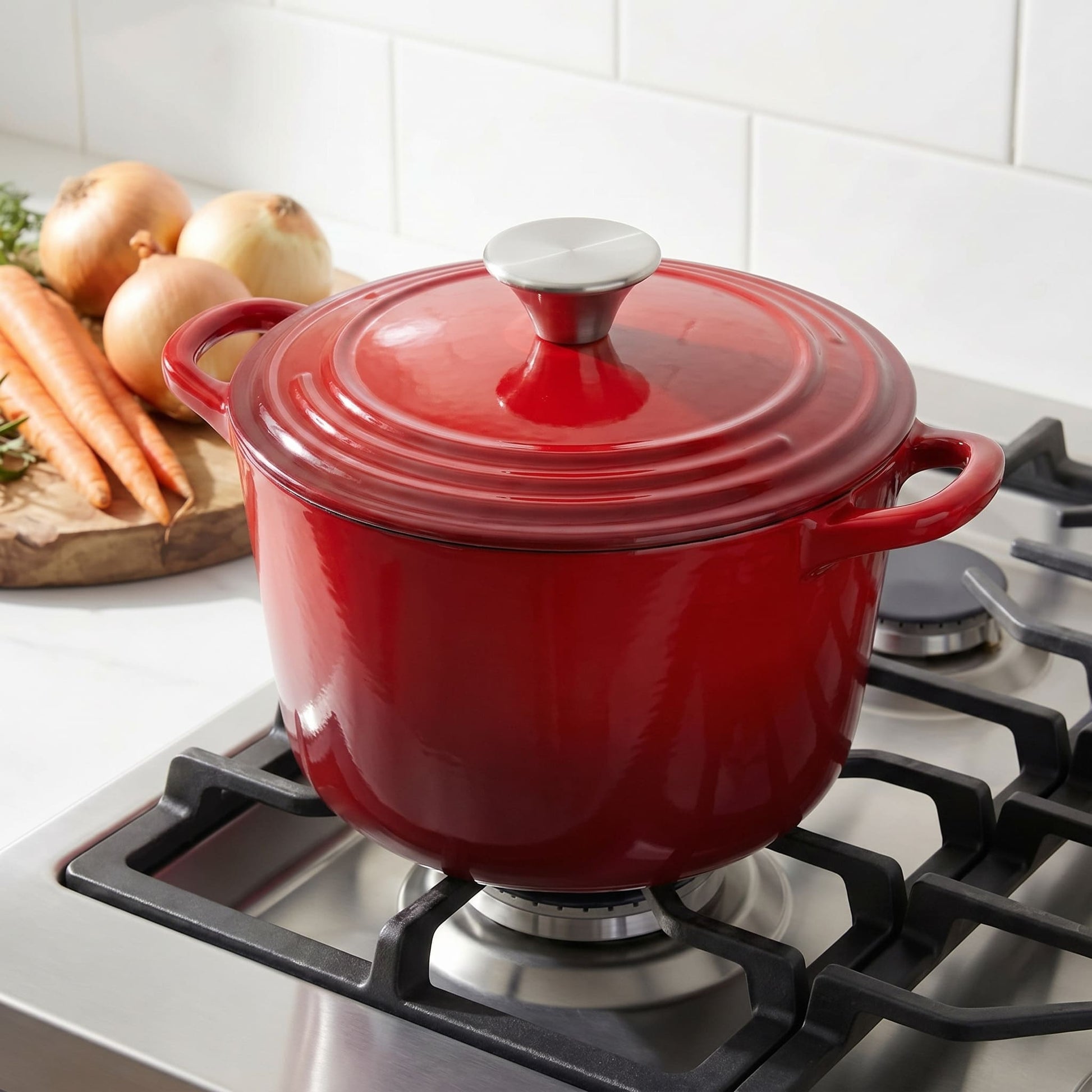 Red deep dutch oven with lid on, on a gas stovetop with vegetables nearby